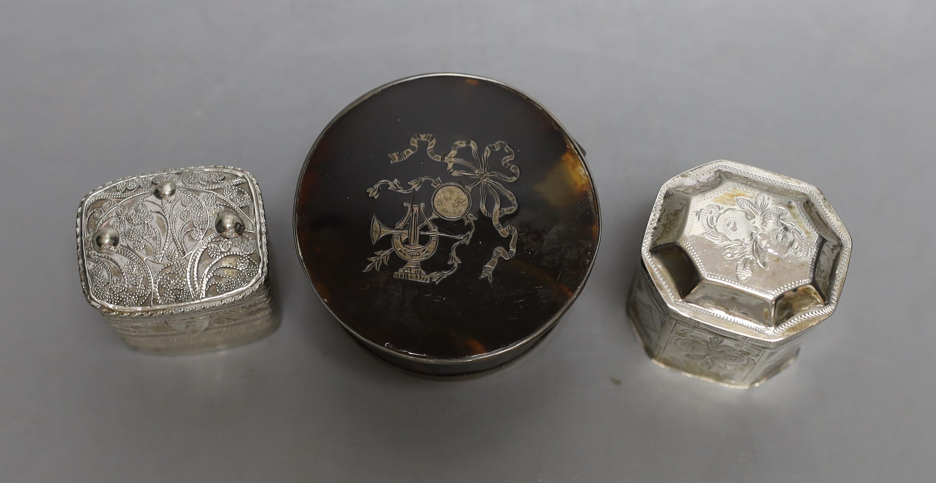 Two Dutch white metal snuff boxes, tallest 42mm and a George V silver mounted tortoiseshell box.